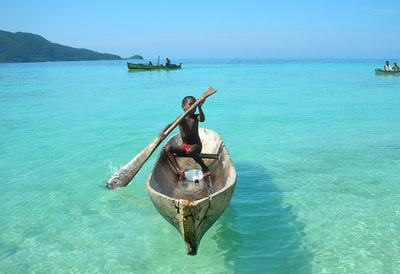 Garifuna boy rowing a boat